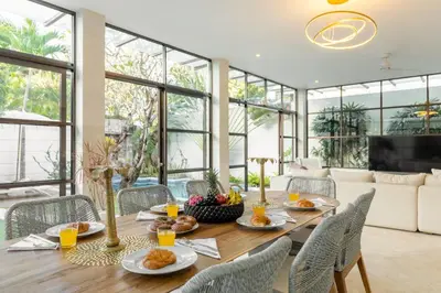 a dining room with a table with food on it at Villa Lumut 3 Bedrooms Central Seminyak in Seminyak