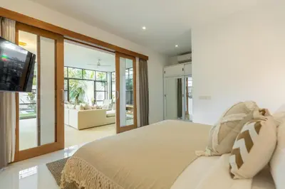 a bedroom with a large bed and a tv at Villa Lumut 3 Bedrooms Central Seminyak in Seminyak