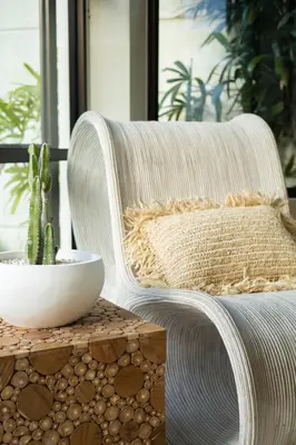 a white rattan chair with a cactus on a table at Villa Lumut 3 Bedrooms Central Seminyak in Seminyak