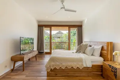 a bedroom with a bed and a balcony at Villa Lumut 3 Bedrooms Central Seminyak in Seminyak