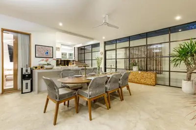 a dining room with a table and chairs at Villa Lumut 3 Bedrooms Central Seminyak in Seminyak