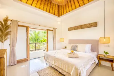 a bedroom with a bed and a large window at Villa Tokyo - 3 BDR Private Villa - 3 min walk to KU DE TA beach in Kuta