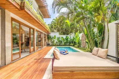 an outdoor patio with a couch and a swimming pool at Villa Tokyo - 3 BDR Private Villa - 3 min walk to KU DE TA beach in Kuta