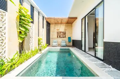 an indoor swimming pool in the middle of a house at Kamaratih Villas by Maheswara in Legian