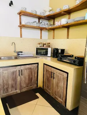 a kitchen with a sink and a microwave at Luka Villas - Luxury 2 Bedroom Private Pool Villa in Seminyak