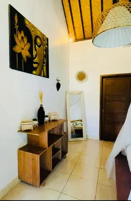 a room with a table and a mirror on the wall at Luka Villas - Luxury 2 Bedroom Private Pool Villa in Seminyak