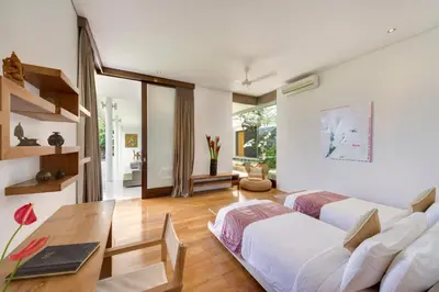 a living room with a white couch and a table at Villa Kavya - 8-minute walk from Berawa Beach in Canggu