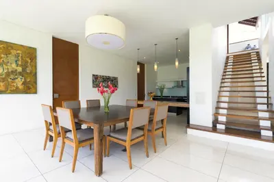 a dining room with a wooden table and chairs at Villa Kavya - 8-minute walk from Berawa Beach in Canggu