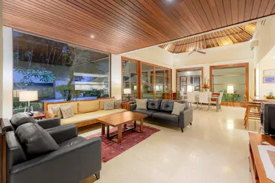 a living room with a couch and a table at Villa Dorado - Steps from Jimbaran Beach in Jimbaran