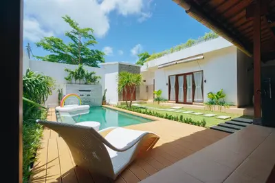 a backyard with a swimming pool and a house at Villa Orked 3 with family room Seminyak in Seminyak