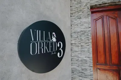 a black and white sign on the side of a building at Villa Orked 3 with family room Seminyak in Seminyak