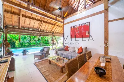 a living room with a couch and a table at Villa Kainara Seminyak by RPM in Seminyak