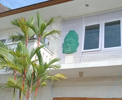 a green head on the side of a house at Villa Filo's Paradise Pool n Spa. Seminyak in Seminyak