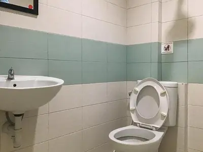 a bathroom with a toilet and a sink at Pondok Mesari Padma Legian RedPartner in Legian