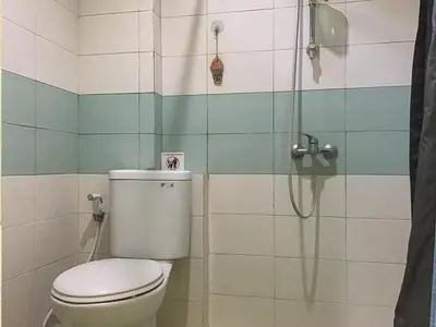a bathroom with a toilet and a shower at Pondok Mesari Padma Legian RedPartner in Legian