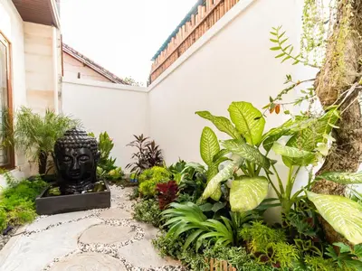 a garden with a statue in the middle of a building at Spacious and Quiet 2 Bd Villa with Pool and Projector in Kerobokan