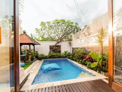 a swimming pool in the backyard of a house at Spacious and Quiet 2 Bd Villa with Pool and Projector in Kerobokan