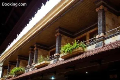 a building with potted plants on top of it at Segara Sadhu Inn Kuta by ecommerceloka in Kuta
