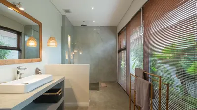 a bathroom with a sink and a large window at Villa Nikaia by Villa Finder in Seminyak
