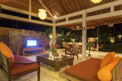 a living room with a couch and a tv on a patio at Villa Liang by Nagisa Bali in Seminyak