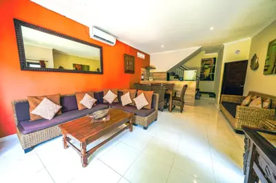 a living room with a couch and a table at Pondok DEWI Villa - LEGIAN - 6 Bedroom Villa - Great Location in Legian