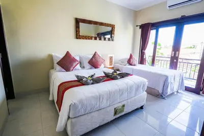a hotel room with two beds and a mirror at Pondok DEWI Villa - LEGIAN - 6 Bedroom Villa - Great Location in Legian