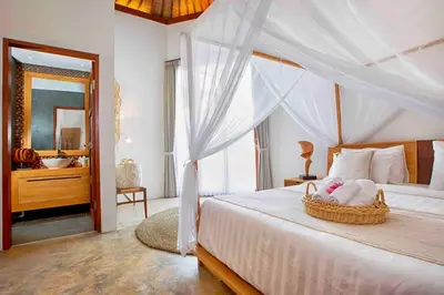 a bedroom with a bed with a basket on it at THE MILAGRO VILLA in Canggu