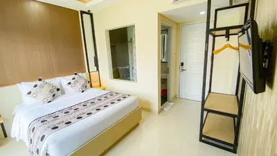 a bedroom with a bed and a ladder in it at Ultimate Residence Bali in Denpasar