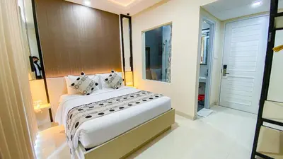 a bedroom with a large bed in a room at Ultimate Residence Bali in Denpasar