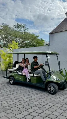 a group of people riding a golf cart at ASAI Village in Jimbaran