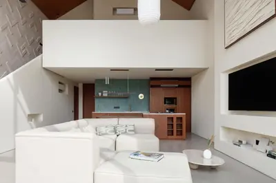 a living room with a white couch and a tv at ASAI Village in Jimbaran