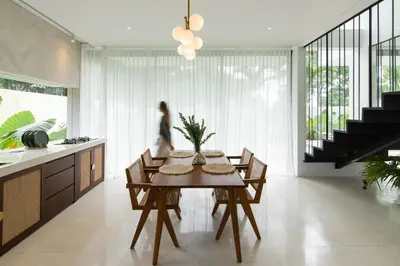 a kitchen and dining room with a table and chairs at ASAI Village in Jimbaran