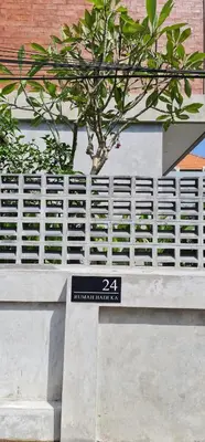 a sign on the side of a building with a tree at Rumah Hadeka Petitenget in Seminyak