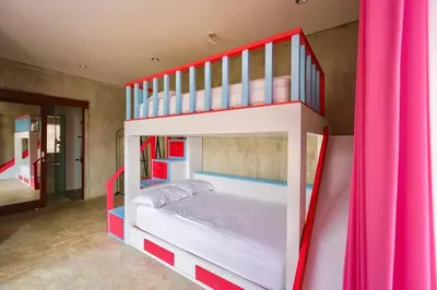 a red and white bunk bed in a room at Villa Cleopatra Bali in Sanur