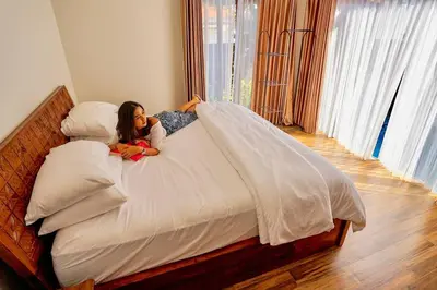 a girl laying on a bed in a bedroom at Villa Cleopatra Bali in Sanur