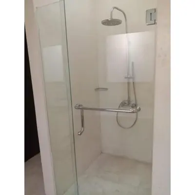 a shower with a glass door and a towel rack at Aldeoz Villa Nusa Dua in Nusa Dua