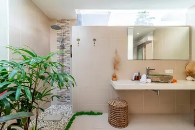 a bathroom with a sink and a mirror at Villa Luna Rose in Seminyak