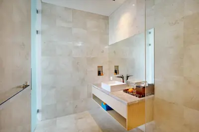 a bathroom with a sink and a glass shower at Eight Palms Villa Seminyak by Ini Vie Hospitality in Seminyak