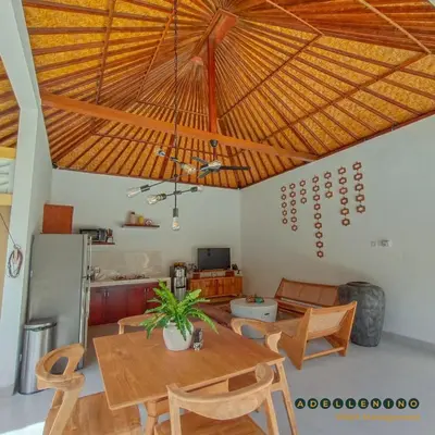 a dining room with a wooden ceiling with a table and chairs at CASA LUWIH Newly Renovated 2BR Villa with Private Pool in Seminyak in Seminyak