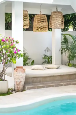 a bed in a room next to a swimming pool at Casa de Lupe 5 bedroom villa in Kerobokan in Seminyak