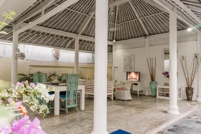 a living room with a table and chairs and a fireplace at Dreams Villa -Private Pool, Fast Wifi, 2 min to Double Six Beach in Seminyak