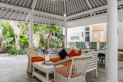 a porch with a couch and chairs and a table at Dreams Villa -Private Pool, Fast Wifi, 2 min to Double Six Beach in Seminyak