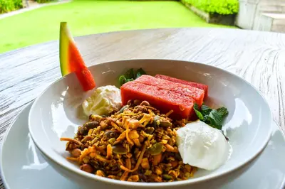a white bowl of food on a table at Chanteak Bali - Stone House 1 in Jimbaran