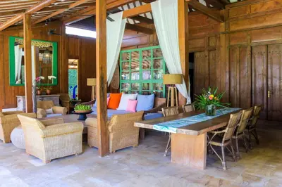 a living room with a table and a couch at Chanteak Bali - Stone House 1 in Jimbaran