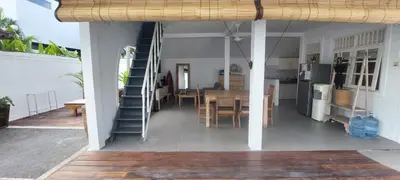 a kitchen and dining area of a house with a staircase at Villa Olivia in Seminyak