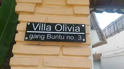 a street sign on the side of a building at Villa Olivia in Seminyak