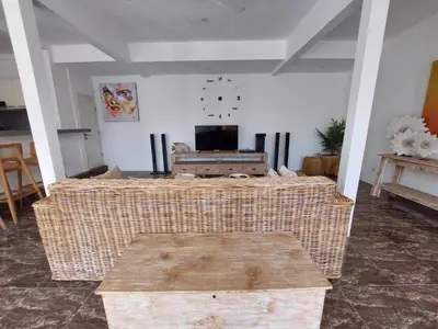 a living room with a television and a table at Villa bale villa in Seminyak