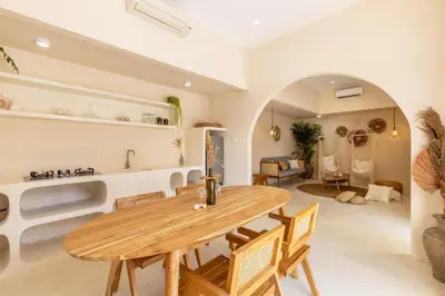 a dining room with a wooden table and chairs at Villa Canggu Beach Coconut - walking distance to Beach & Bars! in Canggu