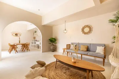 a living room with a blue couch and a table at Villa Canggu Beach Coconut - walking distance to Beach & Bars! in Canggu