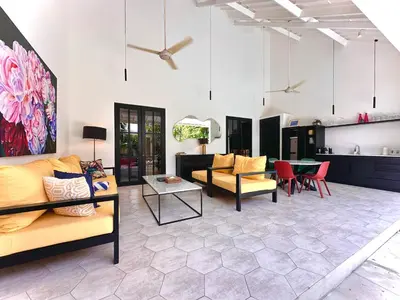 a living room with couches and a table at Villa Harris Canggu in Canggu